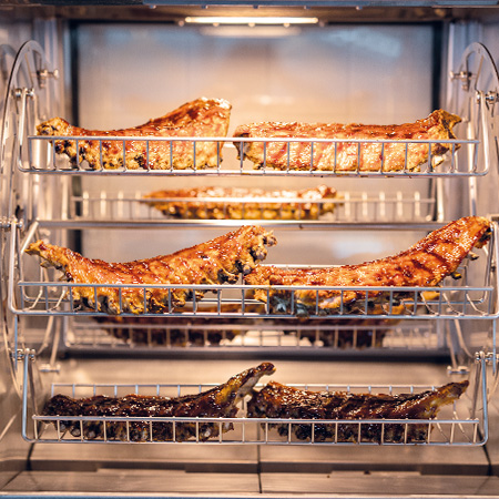 spare ribs grilling or roasting in a fri-jado rotisserie oven