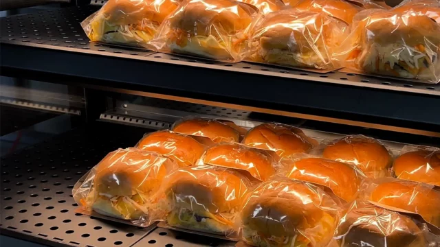 rotisserie hamburgers presented in a hot food display ready to go